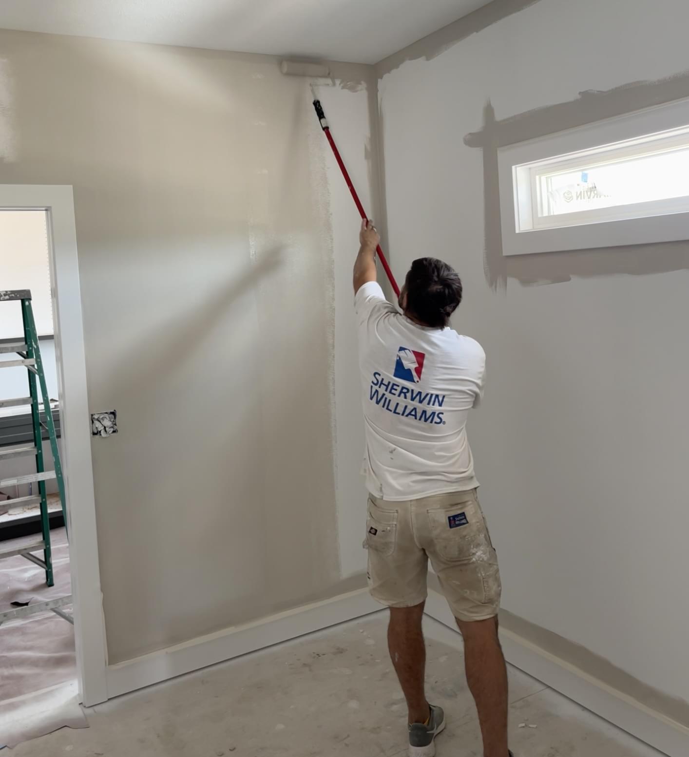 Cutting Edge Painting worker in Sherwin-William's shirt interior painting new home